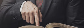 Man pointing at an open Bible